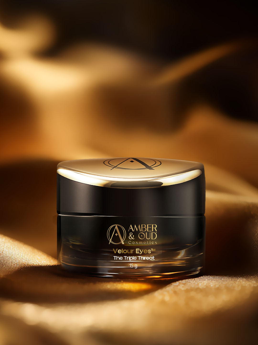 Cosmetic jar with gold lid on a textured gold background